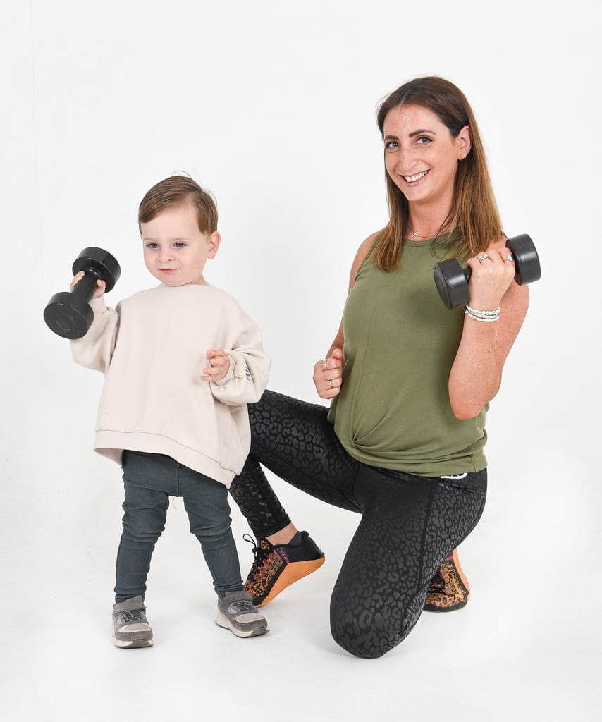 Coach with her toddler holding dumbbells.